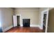 Living room with hardwood floors and a decorative fireplace, doors and closet access at 3033 Semmes St, Atlanta, GA 30344
