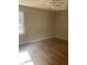 Bright, empty bedroom featuring gleaming hardwood floors and natural light from a side window at 7205 Lakeview Dr, Covington, GA 30014