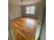 Spacious bedroom featuring hardwood flooring, a window for natural light, and a large closet at 7205 Lakeview Dr, Covington, GA 30014