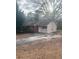 Ranch style home featuring a brick and siding exterior, driveway and a lawn covered with leaves at 7205 Lakeview Dr, Covington, GA 30014