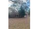 Traditional home featuring a covered front porch and a classic design with mature trees at 7205 Lakeview Dr, Covington, GA 30014