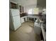 Functional kitchen featuring white cabinets, tiled floors, and a double basin stainless steel sink at 7205 Lakeview Dr, Covington, GA 30014
