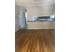 Open-concept living room showing hardwood floors, a breakfast bar, and access to the kitchen area at 7205 Lakeview Dr, Covington, GA 30014
