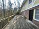 Expansive wooden deck provides an excellent space for outdoor gatherings, surrounded by lush trees and natural beauty at 1600 Whisperwood Trl, Stone Mountain, GA 30088