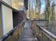 Spacious wooden back deck, great for outdoor relaxation and entertaining, with a view of the surrounding trees at 1600 Whisperwood Trl, Stone Mountain, GA 30088