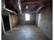Unfinished basement with a window and exposed ductwork at 1600 Whisperwood Trl, Stone Mountain, GA 30088