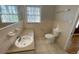Compact bathroom featuring a tiled floor, vanity with sink and a standard toilet at 1600 Whisperwood Trl, Stone Mountain, GA 30088