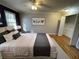 Bedroom with hardwood floors, a large bed, and a closet for storage at 1600 Whisperwood Trl, Stone Mountain, GA 30088