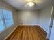 A bright bedroom featuring hardwood floors, a ceiling fan and a window at 1600 Whisperwood Trl, Stone Mountain, GA 30088