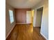 Hardwood floors, natural light, and an open doorway enhance this comfortable bedroom at 1600 Whisperwood Trl, Stone Mountain, GA 30088
