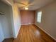Cozy bedroom featuring hardwood floors, a ceiling fan, and a bright window at 1600 Whisperwood Trl, Stone Mountain, GA 30088