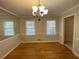 Dining room features hardwood floors, modern lighting, and an adjacent entryway at 1600 Whisperwood Trl, Stone Mountain, GA 30088