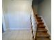 Inviting entryway featuring tiled floors and staircase with wooden handrail and white spindles at 1600 Whisperwood Trl, Stone Mountain, GA 30088