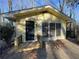 Small yellow detached structure nestled in the trees with a door and deck at 1600 Whisperwood Trl, Stone Mountain, GA 30088