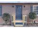 Charming brick home featuring a stylish blue front door and decorative shutters at 1600 Whisperwood Trl, Stone Mountain, GA 30088