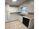Bright kitchen featuring white cabinets, tile floor, and a stainless steel sink at 1600 Whisperwood Trl, Stone Mountain, GA 30088