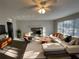 Bright living room features modern furniture, fireplace and large windows that flood the space with natural light at 1600 Whisperwood Trl, Stone Mountain, GA 30088