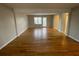 Bright living room showcasing gleaming hardwood floors and ample natural light from large windows at 1600 Whisperwood Trl, Stone Mountain, GA 30088