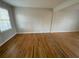 A cozy living room featuring hardwood floors and a window at 1600 Whisperwood Trl, Stone Mountain, GA 30088
