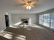 Spacious living room features a stone fireplace and natural light from the large windows at 1600 Whisperwood Trl, Stone Mountain, GA 30088