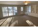 Bright living room with built-in shelving and cabinets, plus large windows for natural light at 1600 Whisperwood Trl, Stone Mountain, GA 30088