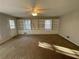 Spacious living room featuring built-in shelving and cabinets, plus plenty of natural light at 1600 Whisperwood Trl, Stone Mountain, GA 30088