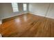 Bright living room with hardwood floors and large windows for plenty of natural light at 1600 Whisperwood Trl, Stone Mountain, GA 30088