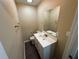 A well-lit half bathroom with a white vanity and a large mirror at 980 Linam Se Ave, Atlanta, GA 30315
