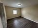 A simple bedroom featuring hardwood floors, natural light and a closet at 980 Linam Se Ave, Atlanta, GA 30315
