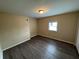 A simple bedroom with hardwood floors and a window at 980 Linam Se Ave, Atlanta, GA 30315