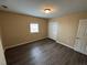 A cozy bedroom with wooden floors, natural light and a closet at 980 Linam Se Ave, Atlanta, GA 30315
