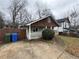 Charming home with a cozy front porch, green lawn, and concrete driveway at 980 Linam Se Ave, Atlanta, GA 30315