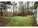 Expansive backyard featuring a wooden deck, lush green lawn and mature trees at 10945 Pinehigh Dr, Alpharetta, GA 30022