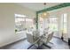 Bright dining area features a marble table, white seating, and a view of the backyard at 10945 Pinehigh Dr, Alpharetta, GA 30022