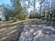 Large backyard with mature trees and a patio at 1864 Cindy Dr, Decatur, GA 30032