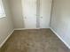 Carpeted bedroom with double closets and neutral colored walls at 1864 Cindy Dr, Decatur, GA 30032
