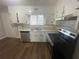 Kitchen with white cabinets, stainless steel appliances, and wood flooring at 1864 Cindy Dr, Decatur, GA 30032