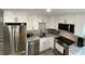 Updated kitchen with stainless steel appliances, white cabinets, and light countertops at 1888 Peeler Rd, Atlanta, GA 30338