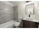 Bathroom featuring a modern vanity, large mirror, and tub and shower combination at 3753 Adamsville Sw Dr, Atlanta, GA 30331