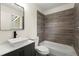 Updated bathroom featuring modern vanity with vessel sink, tub with updated tiling at 3753 Adamsville Sw Dr, Atlanta, GA 30331
