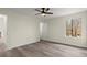 Bright bedroom with modern flooring, a ceiling fan, and a view of the outdoors at 3753 Adamsville Sw Dr, Atlanta, GA 30331