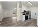Kitchen with stainless steel appliances, white cabinets, and wood-look flooring at 3753 Adamsville Sw Dr, Atlanta, GA 30331