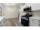 Bright kitchen with modern appliances, white cabinets, stainless steel oven and updated countertops at 3753 Adamsville Sw Dr, Atlanta, GA 30331