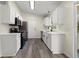 Modern kitchen featuring stainless steel appliances, white cabinets, and wood-look flooring at 3753 Adamsville Sw Dr, Atlanta, GA 30331