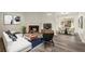 Bright living room with a fireplace, modern furniture, and wood-look flooring at 3753 Adamsville Sw Dr, Atlanta, GA 30331