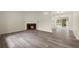 Spacious living room with wood-look flooring and a brick fireplace at 3753 Adamsville Sw Dr, Atlanta, GA 30331