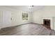 Cozy living room featuring wood-look flooring and a brick fireplace at 3753 Adamsville Sw Dr, Atlanta, GA 30331