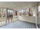 Relaxing screened in porch with painted wood flooring and view of natural surroundings at 3753 Adamsville Sw Dr, Atlanta, GA 30331