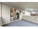 View of the screened in porch with grey wood floors and sliding glass door to kitchen at 3753 Adamsville Sw Dr, Atlanta, GA 30331