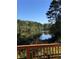 A peaceful view of the lake and surrounding foliage from the backyard at 4380 Serenity Lake Dr, Cumming, GA 30028